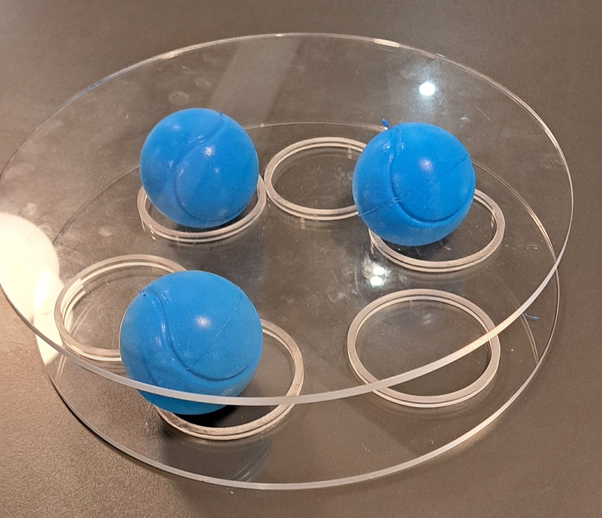 Three foams balls in between two Perspex discs.